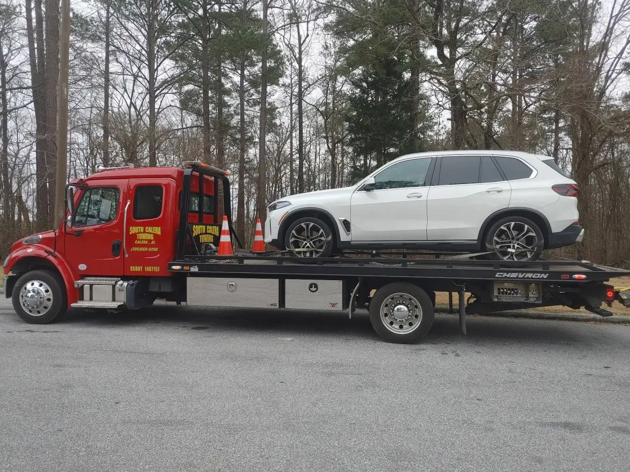 White BMW X5 on a South Calera Towing rollback