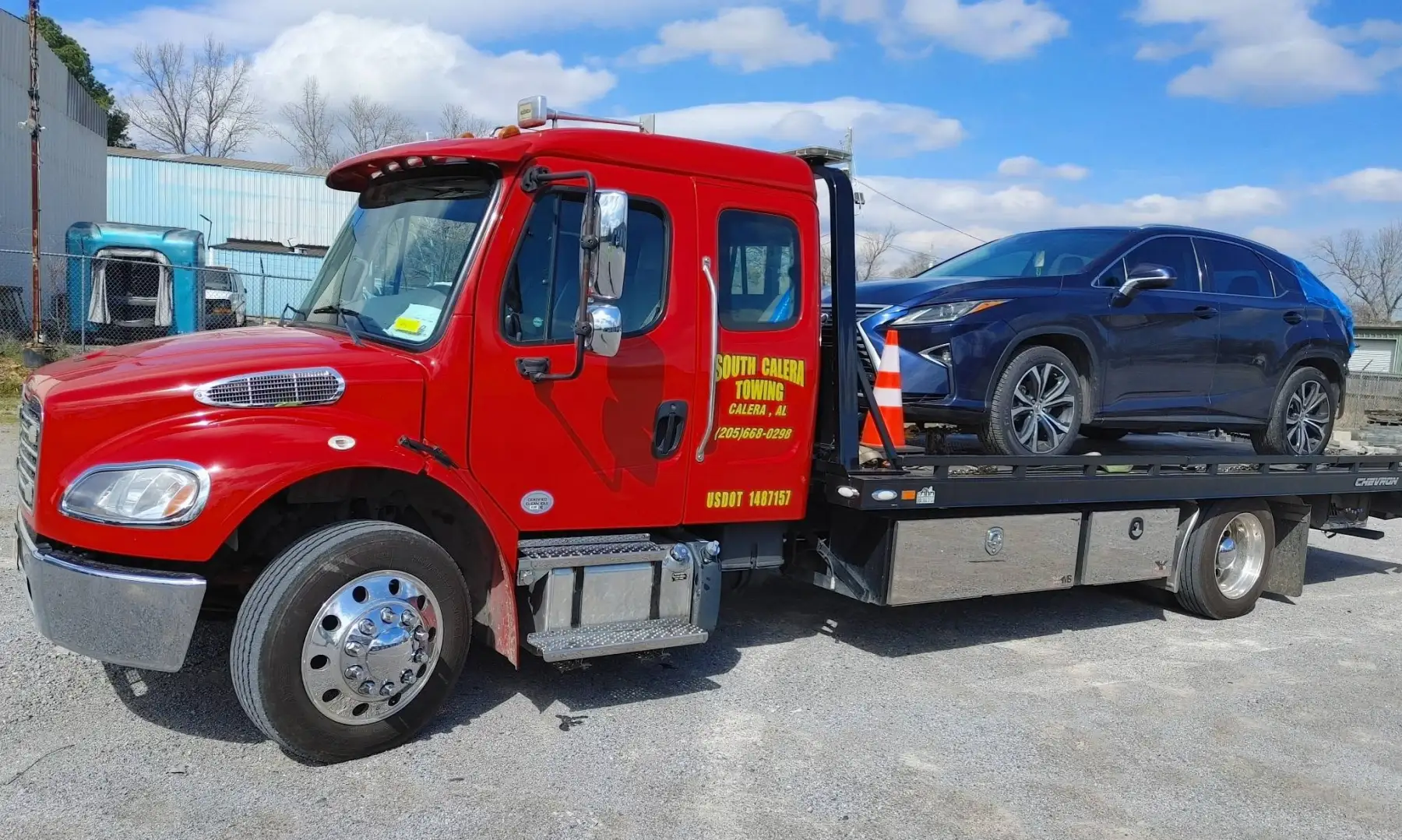 Red South Calera Towing rollback with an SUV on the bed