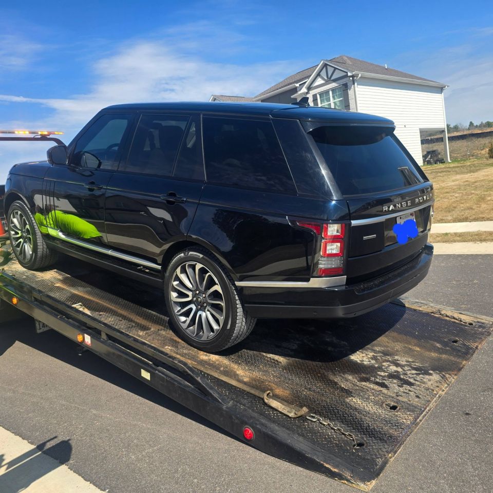 Black Range Rover on the Rollback